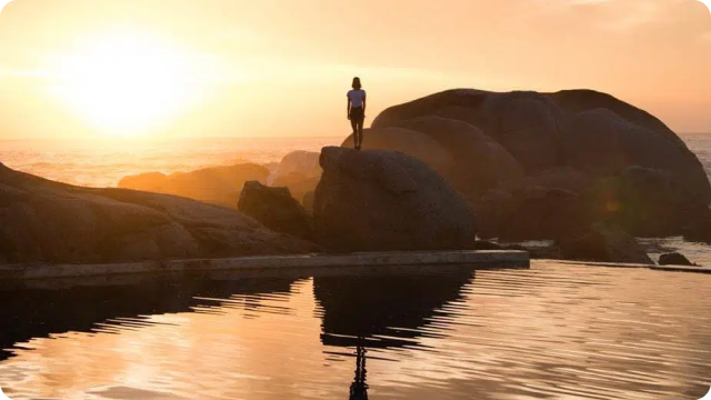 Sunset by rocky shore